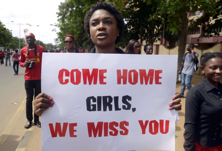Image: A woman carries placard to press for the release of missing Chibok school girls