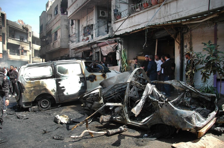 Image: Syrian policemen and citizens inspect the damage at the site of a car bomb explosion in the Abbasid neighborhood in Homs province on April 29.