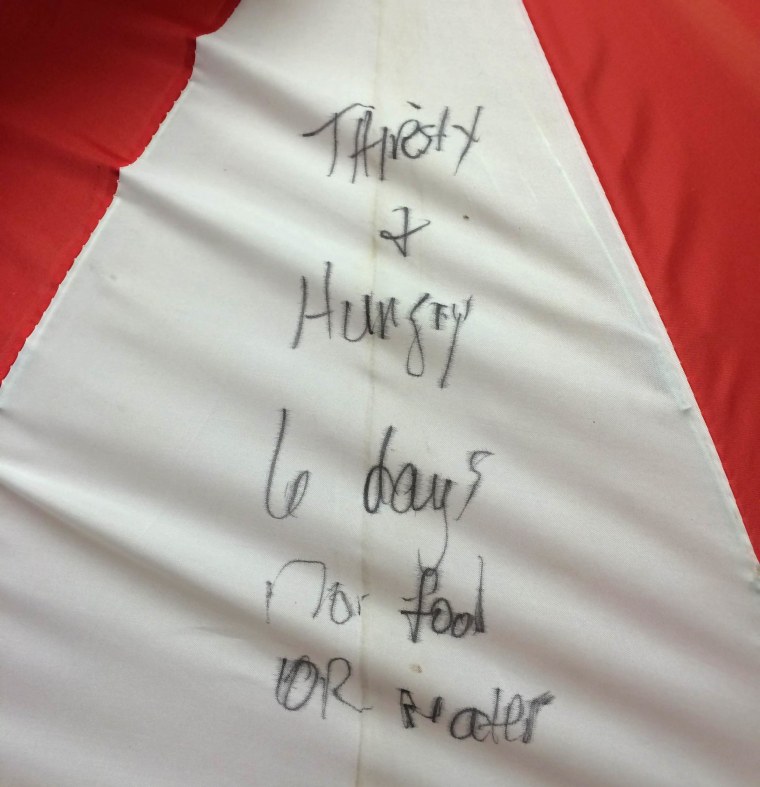 Image: Kristin Hopkins wrote messages on an umbrella and stuck it out her wrecked car window