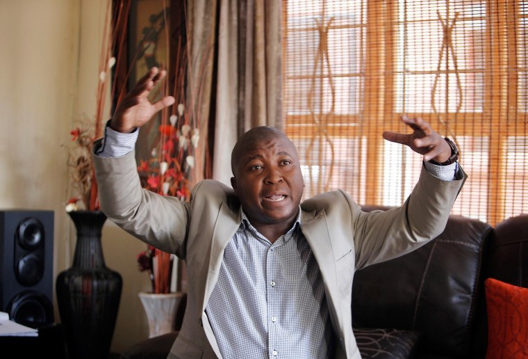Image: Thamsanqa Jantjie gesticulates at his home during an interview