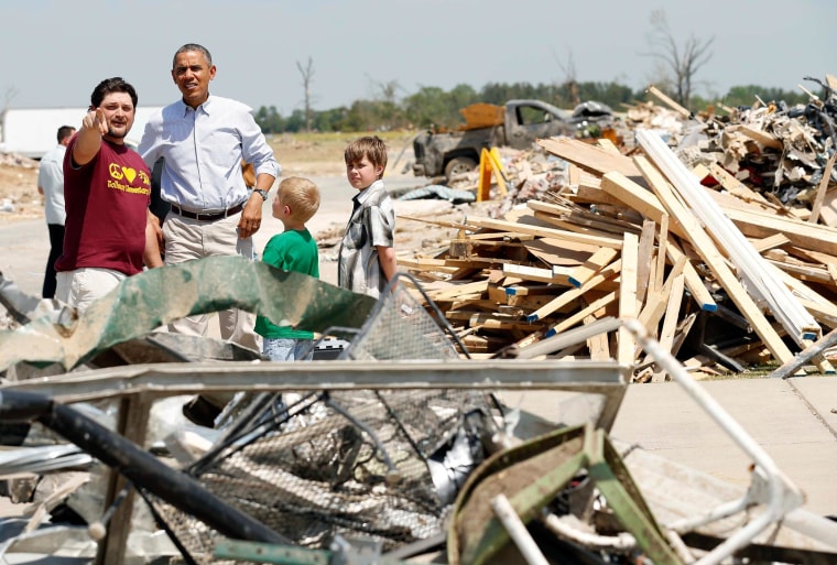 President Barack Obama talks with Daniel Smith and sons Gabriel Dority (R) and Garrison Dority as he visits the tornado devastated town of Vilonia, Arkansas May 7, 2014.