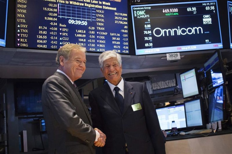 Omnicom Chief Executive Wren and Publicis Group Chairman and CEO Levy shake hands after announcing an agreement on their merger on the floor of the New York Stock Exchange