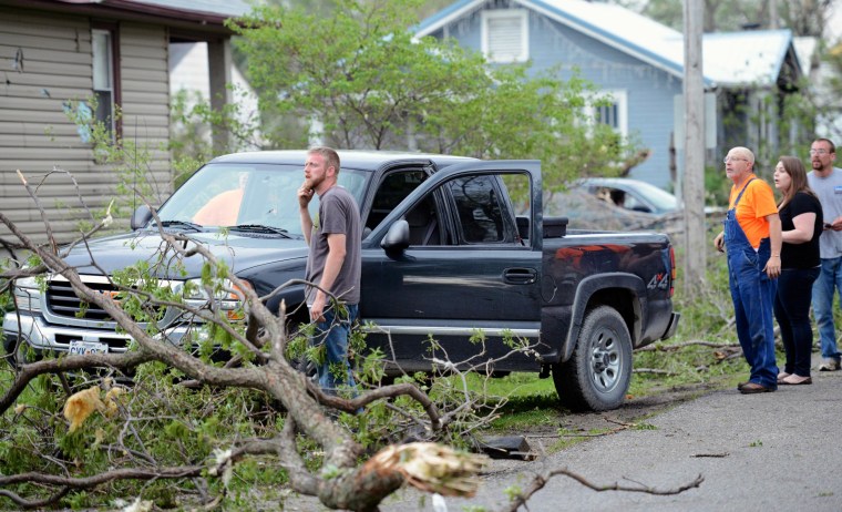 Image: Orrick residents look at the damage after a storm damaged hundreds of homes