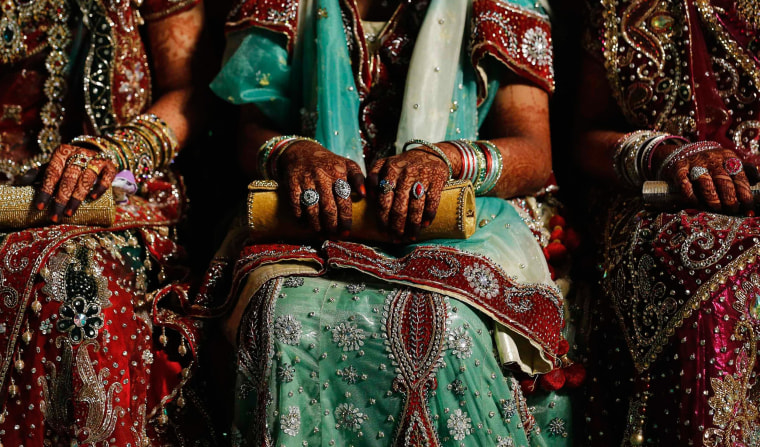 Image: Muslim brides wait for start of mass marriage ceremony in Mumbai