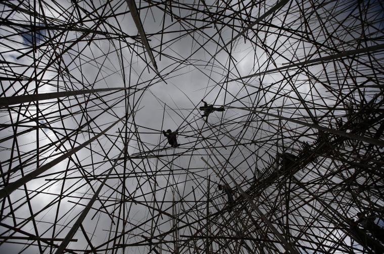 Image: Professional rock climbers work on the art installation in Jerusalem