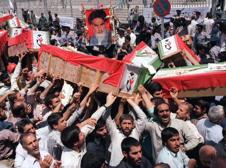 Image: Mourners carry coffins through the streets of Tehran on Thursday, July 7, 1988 during a mass funeral