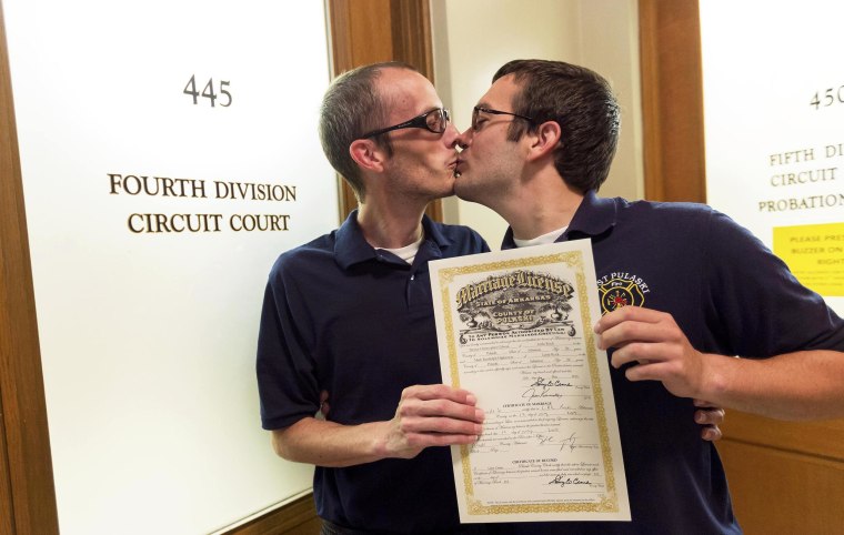 Image: Steven Gibson and Mark Hightower kiss after their marriage ceremony at the Pulaski County Courthouse in Little Rock