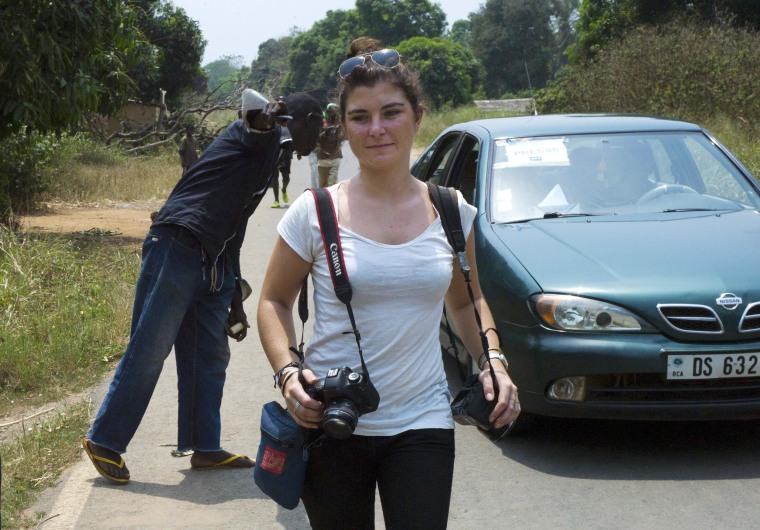 French journalist Camille Lepage walks with her cameras in Damara, 70km north from Bangui, on Feb., 21, 2014. French journalist Camille Lepage, 26, has been killed while on a reporting assignment in Central African Republic, French President Francois Hollande said on May 13.