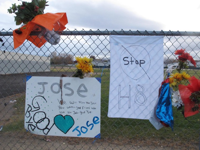 Image: Friends have added a message to Jose Reyes and a small wooden cross at a memorial