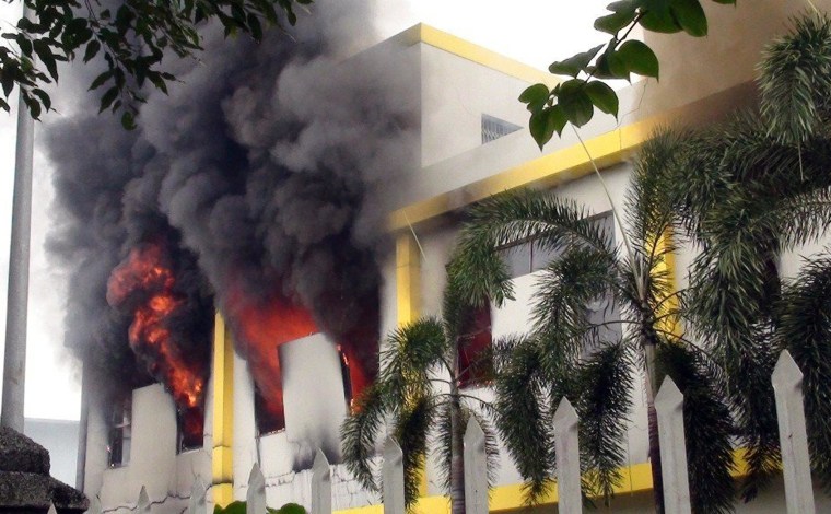 Image: Smoke and flames billow from a factory window in Binh Duong