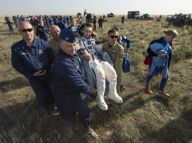 Image: Expedition 39 Commander Koichi Wakata is carried in a chair to a medical tent just minutes after landing in a Soyuz spacecraft.
