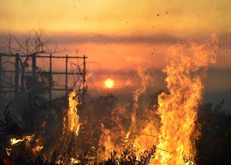 Image: Flames burn on hill in San Marcos, California on Wednesday