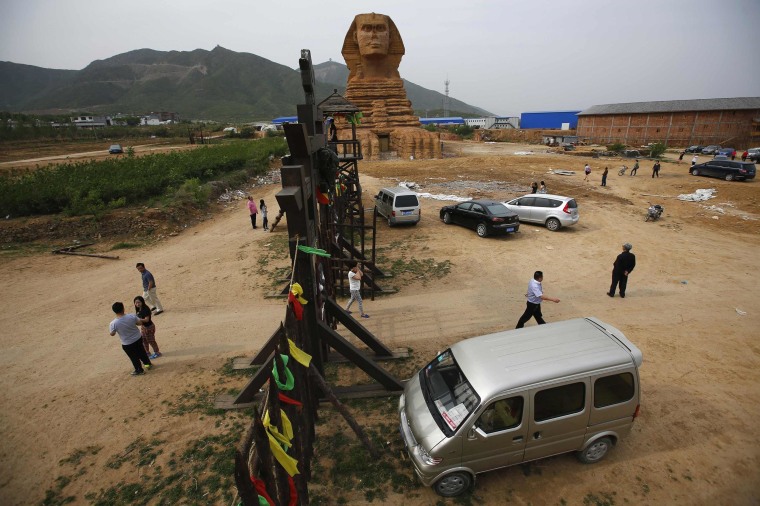 Image: People visit a full-scale replica of the Sphinx, which is part of an unfinished theme park that will also accommodate the production of movies, television shows and animation, on the outskirts of Shijiazhuang