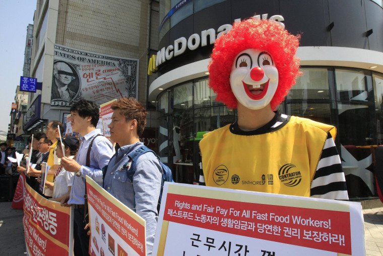 A protester dressed as Ronald McDonald participates in a rally to demand higher wages for fast-food workers outside a McDonald's restaurant in Seoul, South Korea.