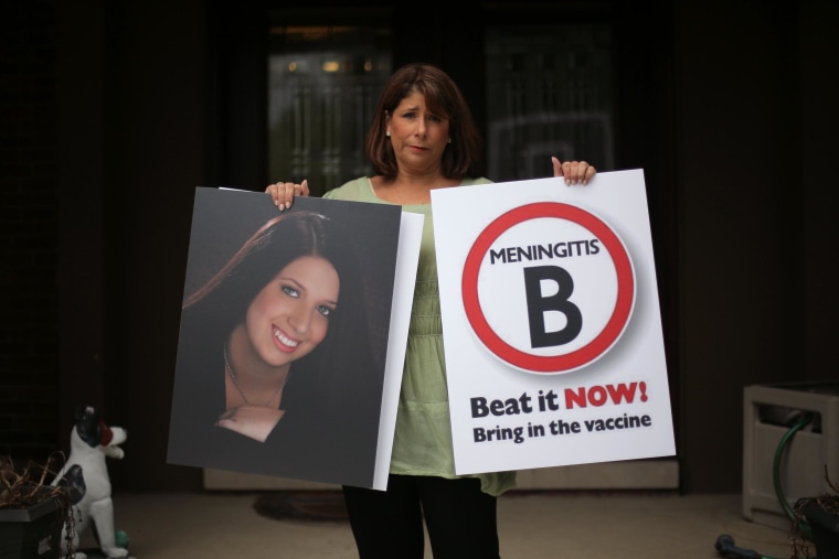 Image: Alicia Stillman holds a portrait of her 19-year-old daughter, Emily, who died in February 2013 from meningitis.