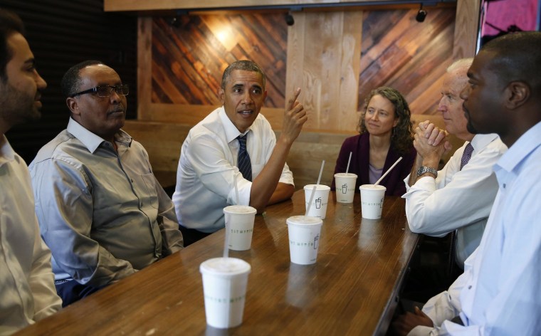 Image: U.S. President Obama talks while having lunch with Vice President Biden and construction workers at Shake Shack in Washington