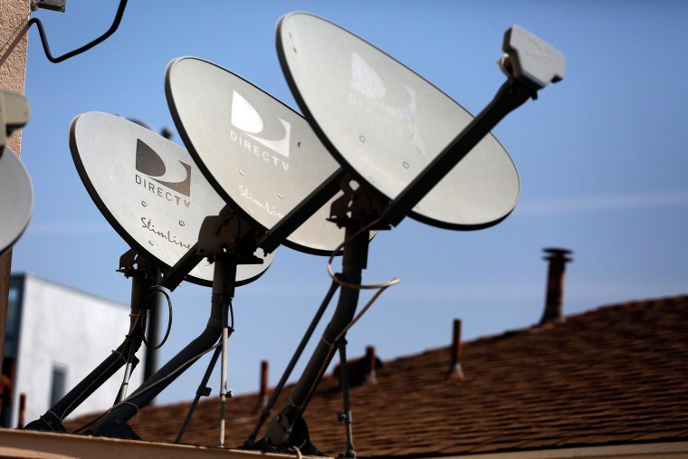 Image: DirecTV satellite dishes sit atop an apartment roof in Los Angeles, Calif.