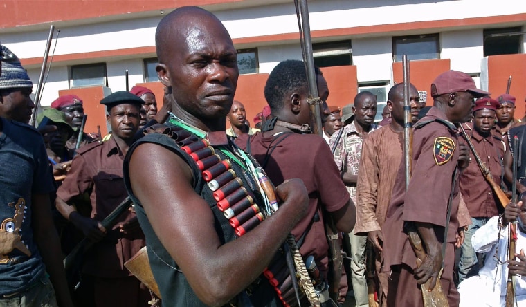 Armed hunters gather before looking for around 300 abducted school girls in Maiduguri, Nigeria on May 18, 2014. Hundreds of hunters armed with homemade rifles, poisoned arrows and amulets say their spiritual powers can lead them to the nearly 300 schoolgirls abducted by Islamic extremists.  