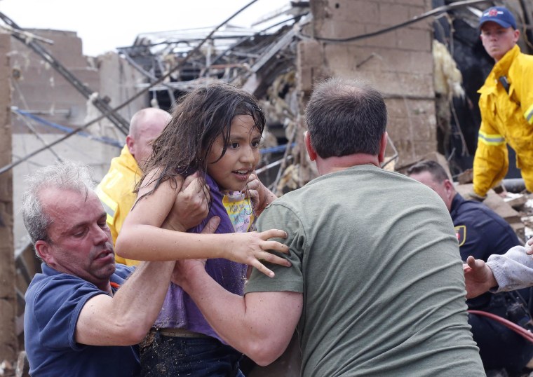 Image: A child is pulled from the rubble of the Plaza Towers Elementary