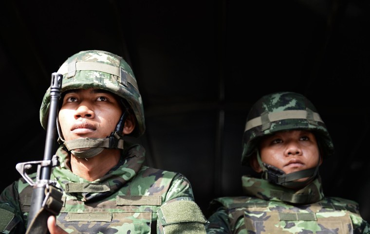 Image: Thai soldiers sit in an army truck outside the Government Public Relations Department