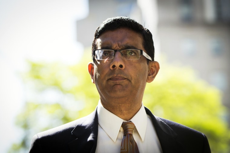 Image: Conservative commentator and best-selling author, Dinesh D'Souza exits the Manhattan Federal Courthouse after pleading guilty in New York