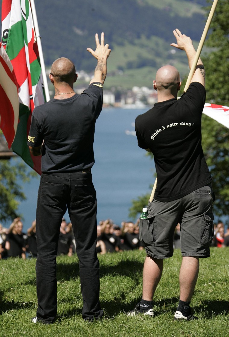Right-wing extremists give fascist salutes during a Swiss national holiday celebration on the Ruetli