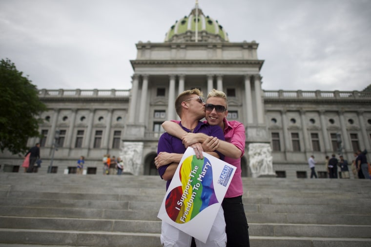 Image: A couple embraces on the Pennsylvania State Capital steps following a rally with gay rights supporters in Harrisburg