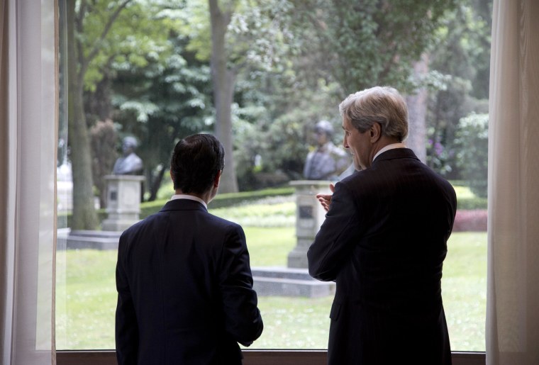 Image: U.S. Secretary of State Kerry and Mexico's President Pena Nieto look out over the grounds from inside Los Pinos presidential residence in Mexico City