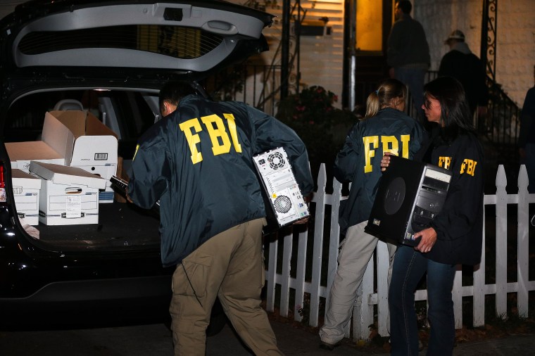 Image: FBI agents remove evidence from the Brooklyn residence of Rabbi Mendel Epstein during an investigation