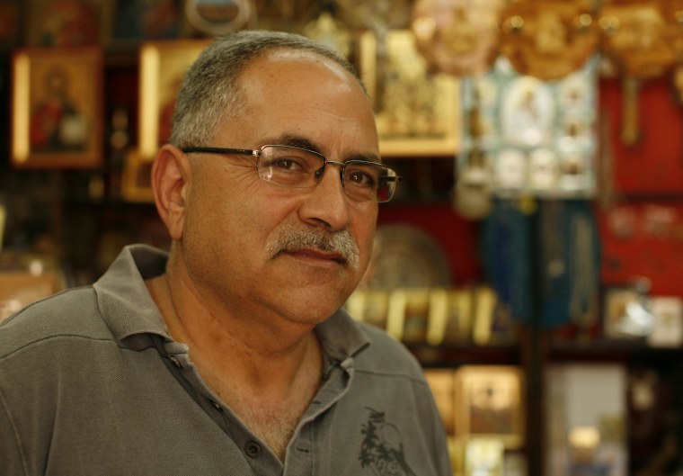 Alfred Ra'ad stands in his shop in the Christian Quarter of Jerusalem's Old City.