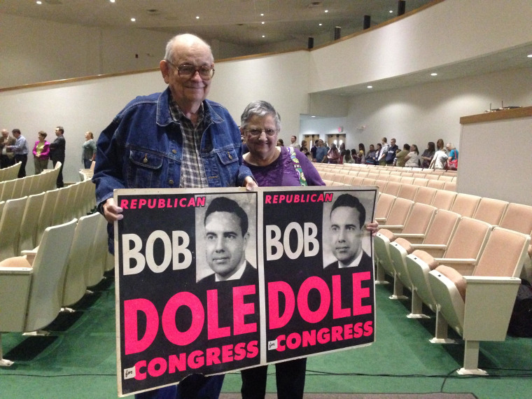 Dole supporters at the Wichita State University auditorium hold a campaign poster from the 1960s.