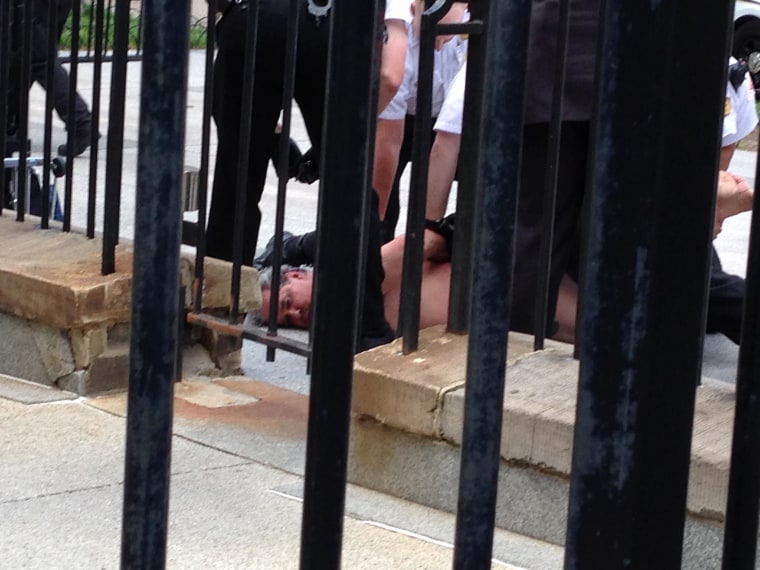 Image: A man stripped naked in front of the White House on Friday afternoon, but was quickly covered up and subdued by officers, according to the Secret Service.