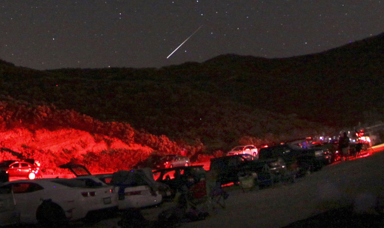 A Camelopardalid meteor flashes north of Castaic Lake in California on Friday night. Cars lined up to catch sight of what some hoped might be a meteor storm, but the show didn't live up to expectations.