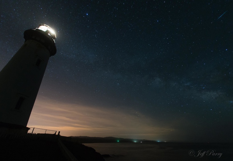 Image: A meteor shoots across the sky as seen from Pigeon Point Lighthouse in California.