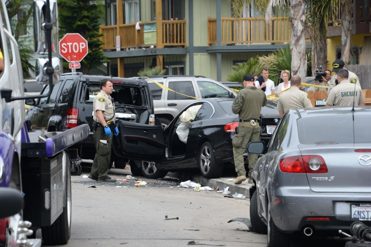 Image: Investigators inspect the suspected gunman's car