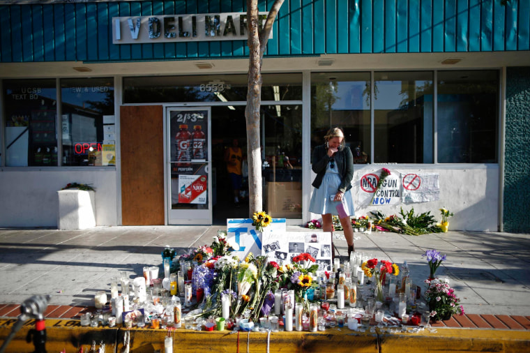 Image: A woman cries in front of a makeshift memorial for UCSB student Christopher Michael-Martinez in Isla Vista