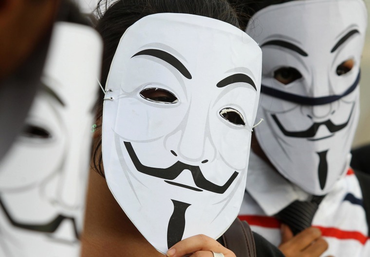 Image: Activists supporting the group Anonymous wear masks