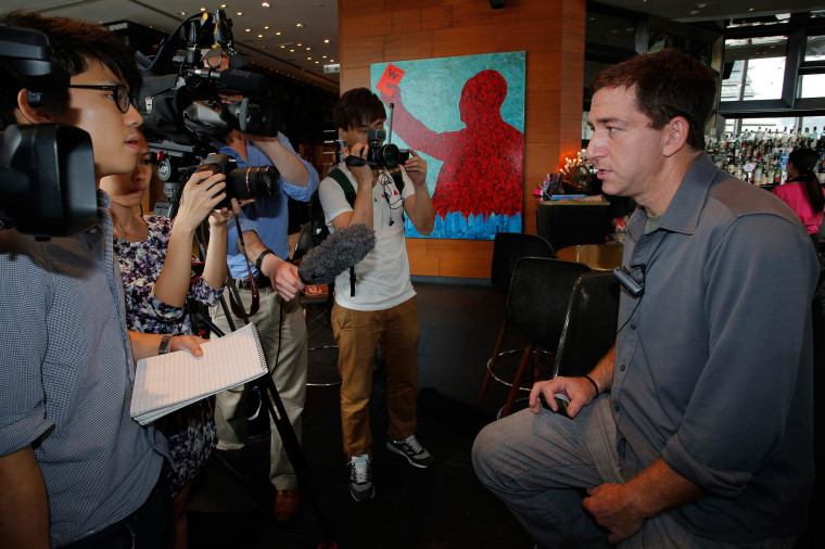 Image: Glenn Greenwald, right, a reporter for The Guardian newspaper, speaks to media at a hotel in Hong Kong June 10, 2013
