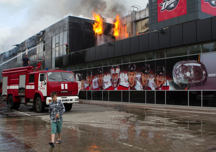 Image: Firefighters attempt to extinguish a fire at the sports arena \"Druzhba\" in Donetsk