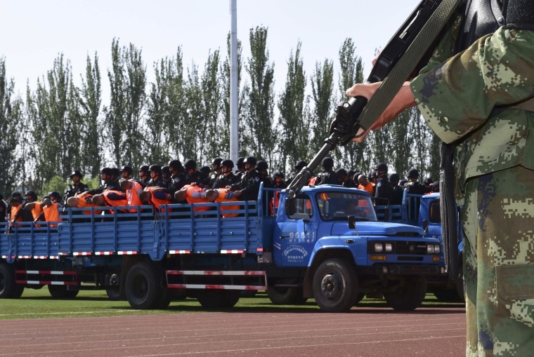 Image: Criminals and suspects are transported to a stadium for a mass sentencing rally in Yili, Xinjiang Uighur Autonomous Region