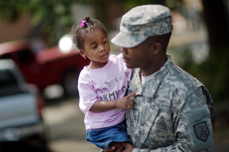 Image: Anslee Harvey, 3, is carried by her father Pfc. Michael Harvey, of Atlanta, with the Georgia National Guard 876th Vertical EN Company