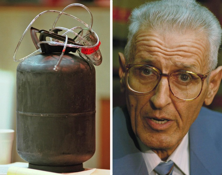 A carbon monoxide tank and mask sit on the prosecutor's table in l996 in the assisted suicide trial of retired pathologist Dr. Jack Kevorkian, right.