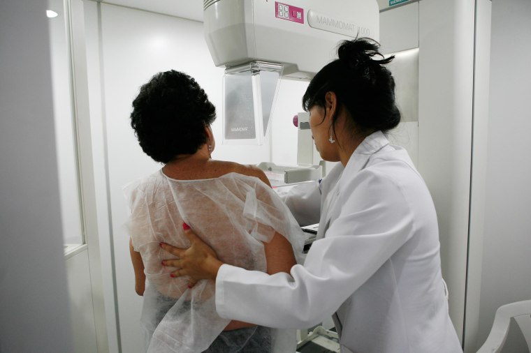 Image: A woman undergoes a mammogram