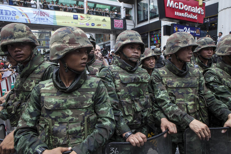 Image: Soldiers stand guard as anti-coup protesters rally in Bangkok, Thailand