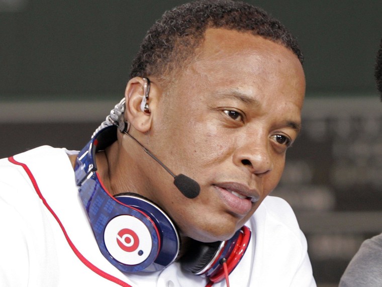 Recording artist Dr. Dre wears a pair of Beats headphones as he attends the MLB 2010 season opener in Boston.