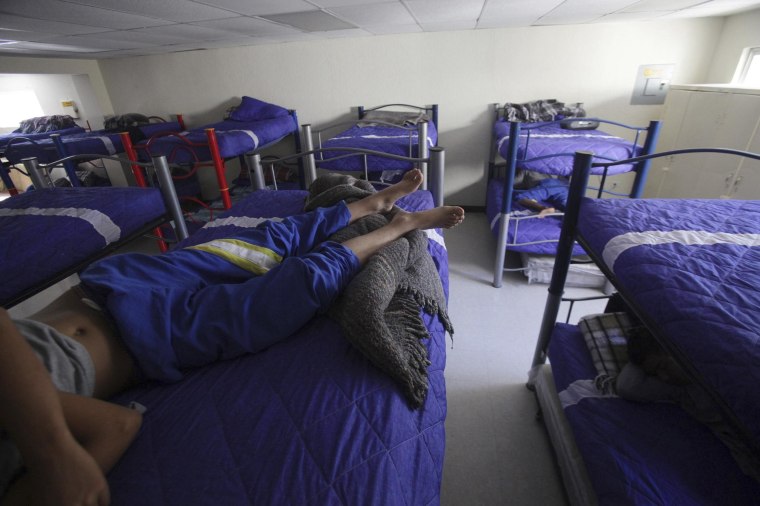 Image: Boys lie down as they rest in bunk beds at the shelter for underage immigrants and repatriated minors \"Mexico, my home\" in Ciudad Juarez
