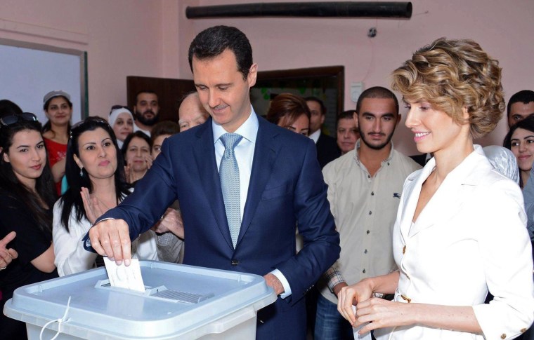 Image: Syrian President Bashar al-Assad and his wife Asma al-Assad casting their votes at a polling station