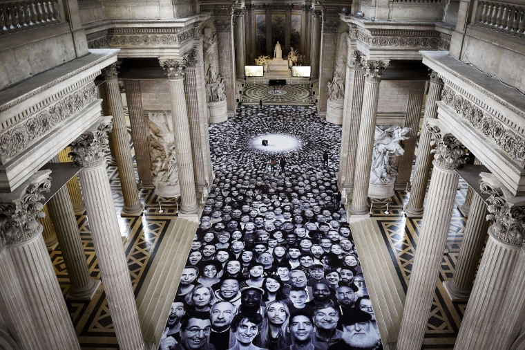 Image: Photos from a project by French photographer JR are displayed on the ground of the Pantheon in Paris