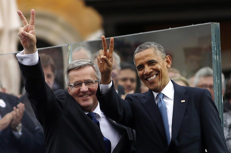 Image: President Barack Obama and Polish President Bronislaw Komorowski gesture at a Freedom Day event at Royal Square in Warsaw