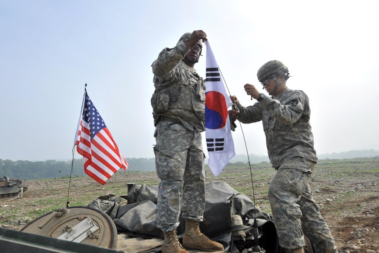 U.S. soldiers from 2nd Infantry Division hang a South Korean flag on the top of their M1A2 tank